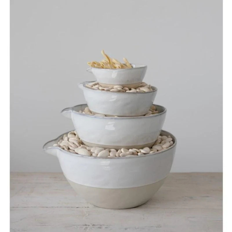 Stacked white and natural ceramic batter bowls in varying sizes. Half cup, two cups, four cups, and eight cups. 