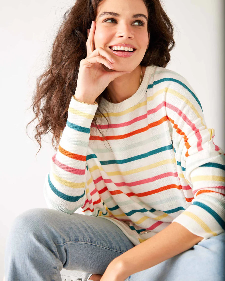 Woman wearing rainbow striped Catalina Sweater