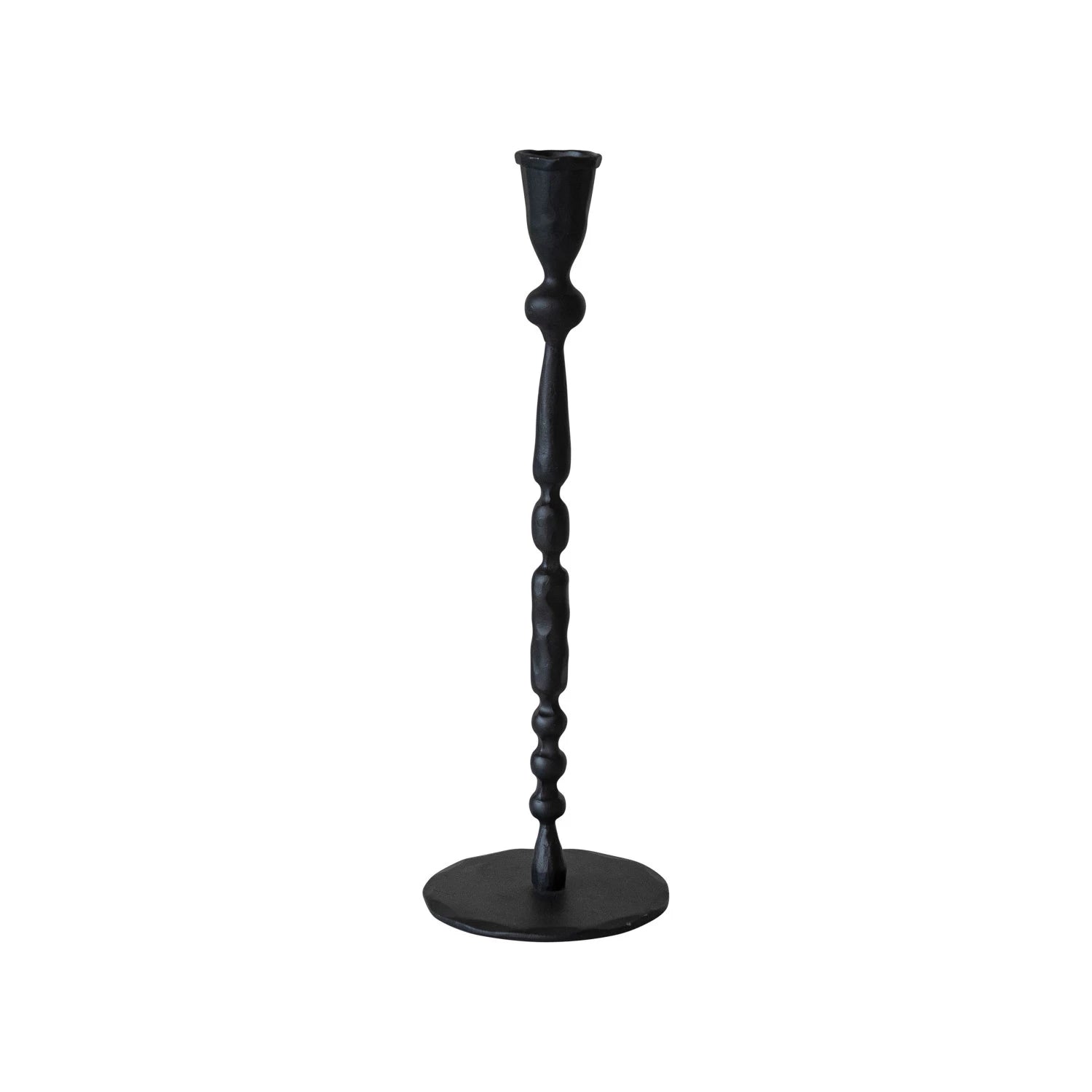 Black cast iron candlestick holder on a white background