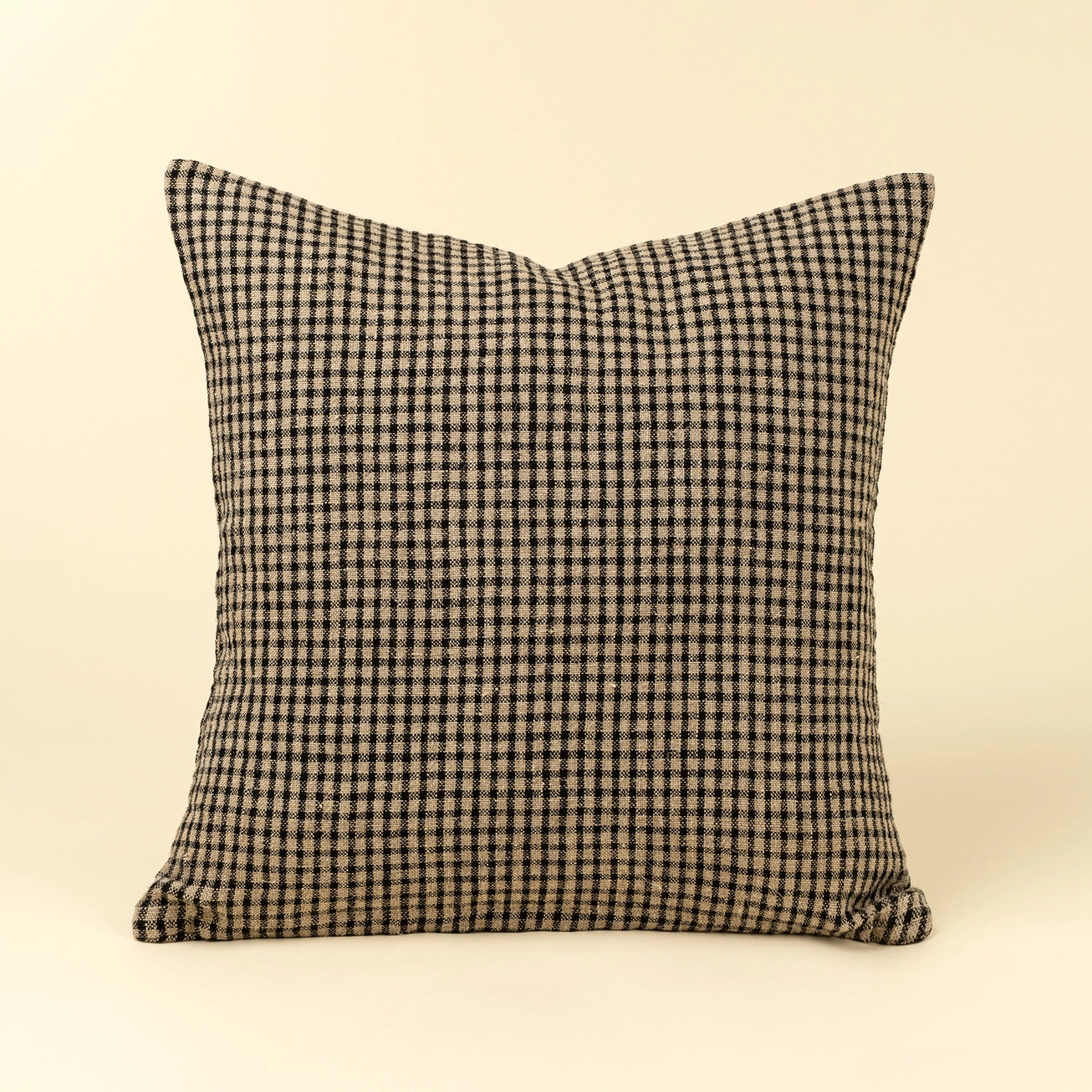 Twenty inch square feather down decorative pillow in a classic black and cream windowpane stripe pattern. 