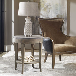 Side table with curved wood legs and solid concrete top in a living room setting.