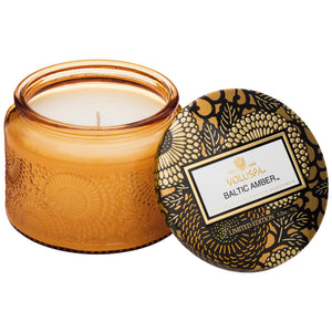 3.2 ounce glass candle votive in scent Baltic Amber from Voluspa. 