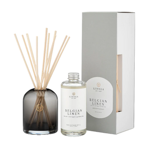 Diffuser set with sticks and bottle labeled 'Belgian Linen' by Linnea on a white background
