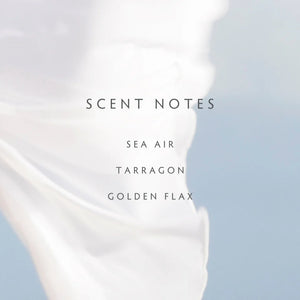Text displaying 'SCENT NOTES' and 'Sea Air', 'Tarragon', 'Golden Flax' on a blurred background.
