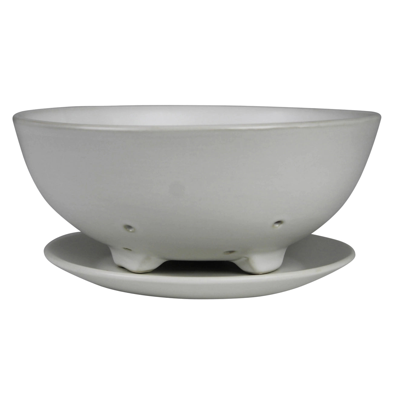 White ceramic footed berry bowl with matching saucer against a white background. 