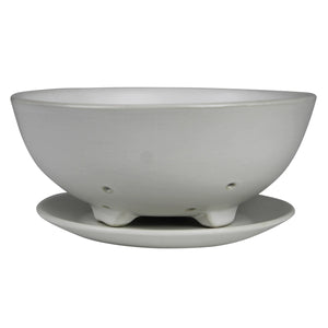 White ceramic footed berry bowl with matching saucer against a white background. 