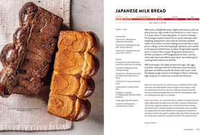 A printed recipe page showing a large photograph of two golden-brown Japanese milk bread loaves on the left and recipe text titled 'JAPANESE MILK BREAD' on the right. "Big Book of Bread".
