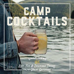 Book cover of 'Camp Cocktails' by Emily Vikre with a person holding a cocktail by a lake.
