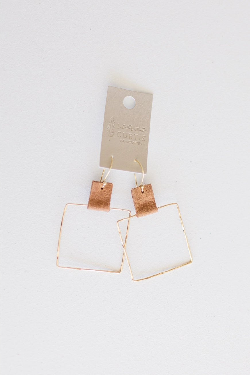 Two inch hammered gold square with saddle leather hoop earrings. Leslie Curtis. 