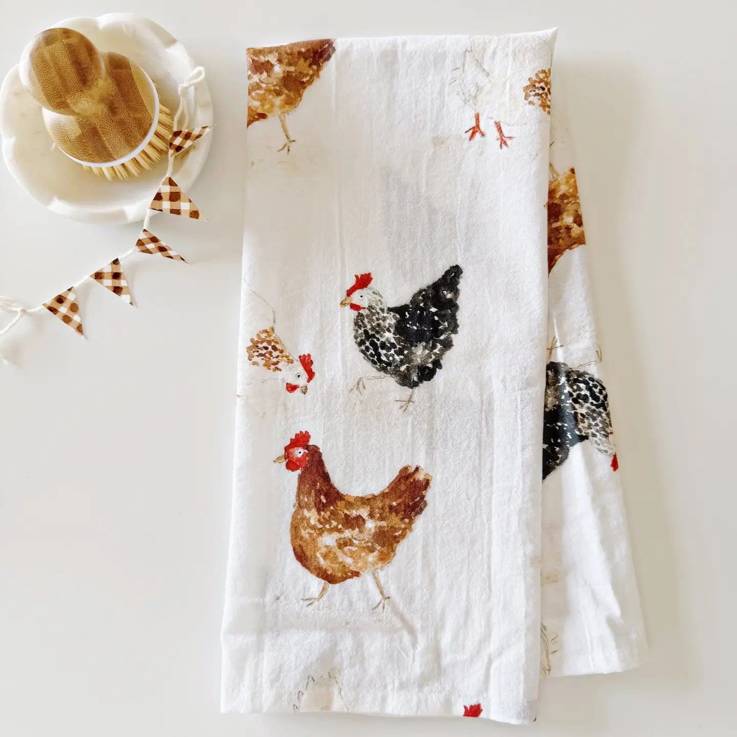 Cotton kitchen towel with chicken pattern on a white surface. Emily Lex Studio. 