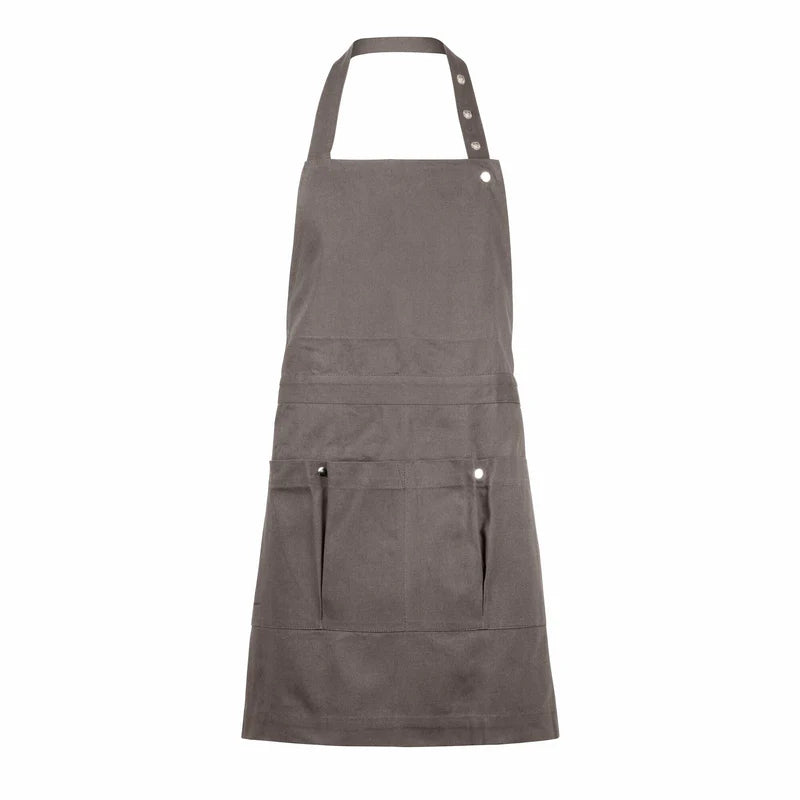 Clay colored organic cotton apron with multiple pockets on a white background. The Organic Company. 