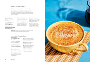 An open cookbook spread showing the recipe for Classic Mocha. The left page contains text for Classic Mocha and Homemade Chocolate Sauce with step-by-step instructions, while the right page features a close-up photo of a golden-brown chocolate mocha cake topped with cocoa powder, served on a wooden plate over a blue surface.