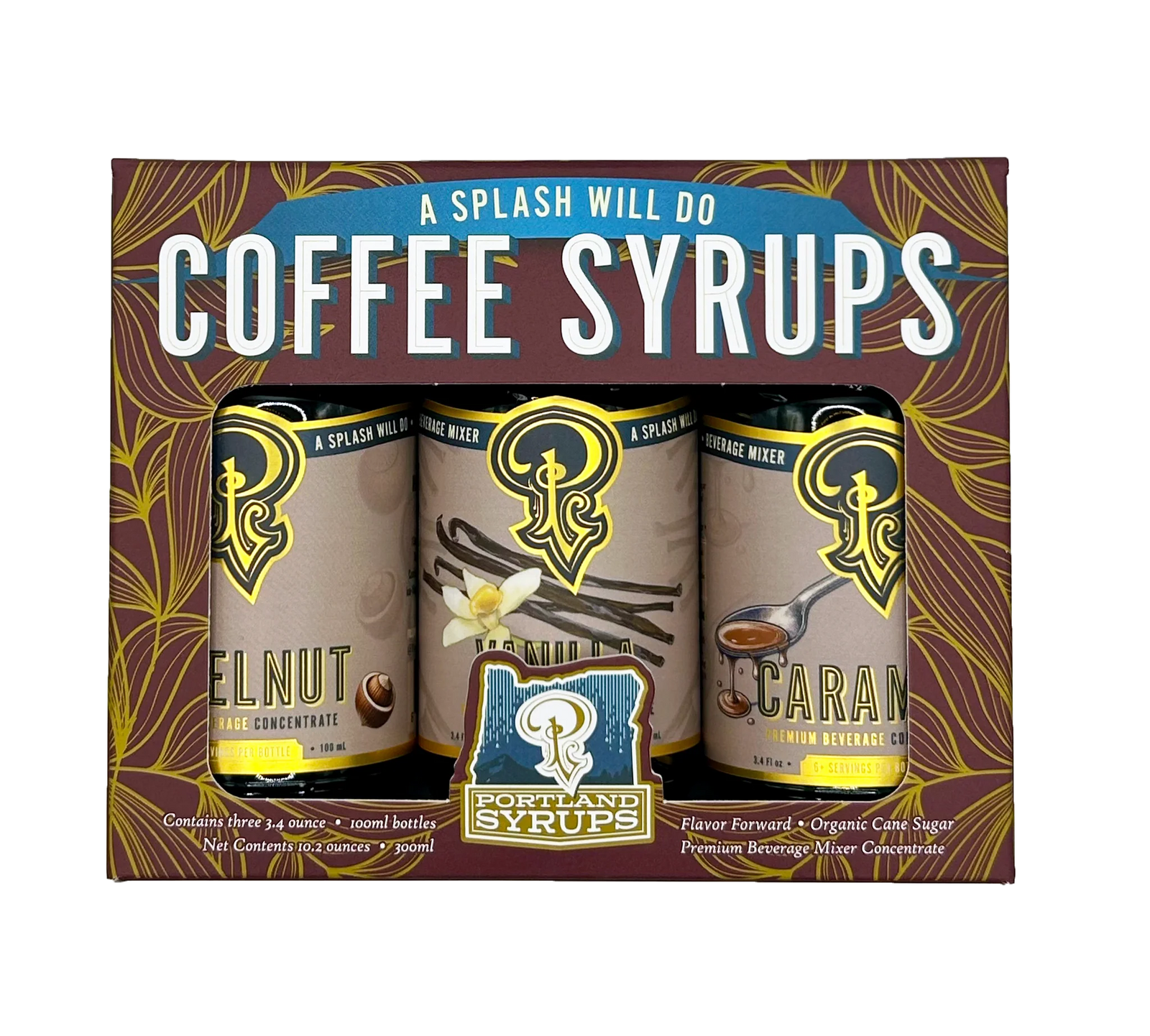 Portland Syrup Company 'A Splash Will Do' coffee syrups gift set in a brown box with gold leaf patterns, featuring three 12 fl oz cans of Nutmeg, Vanilla, and Carafe flavors.