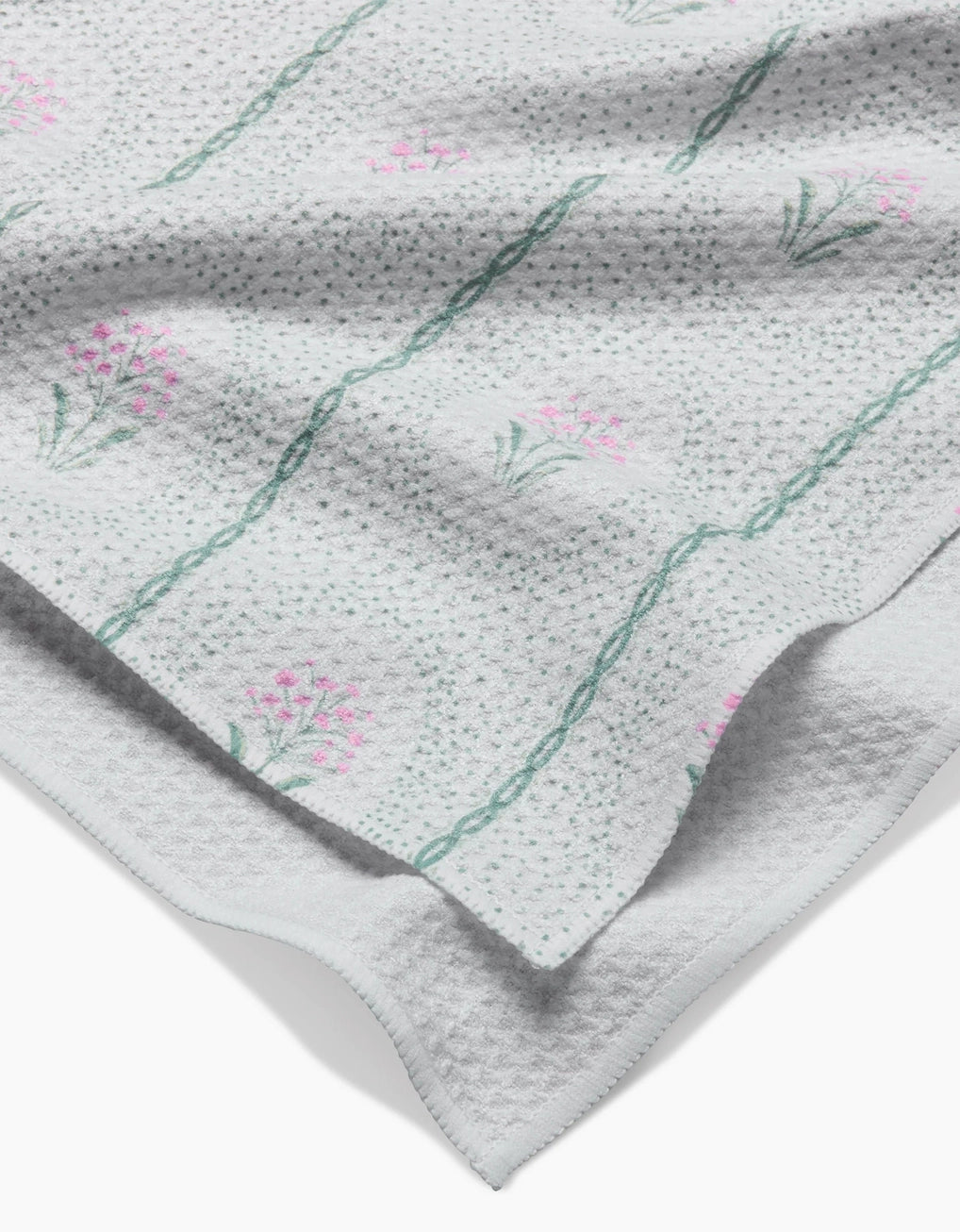 Geometry tea towel with dainty cottage floral pattern on a white background. 
