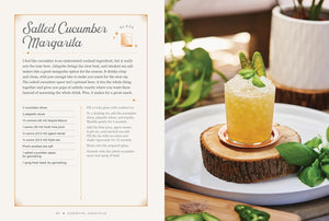 A split-page cocktail recipe card for 'Salted Cucumber Margarita' shown beside a plated prepared drink on a wood slice with cucumber garnish and green leaves.