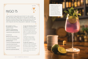 A cocktail recipe page from a book titled 'HUGO 75' with text on the left and a prepared pink drink in a coupe glass on the right, set against a warm bar background with a lime wedge and a small candle.