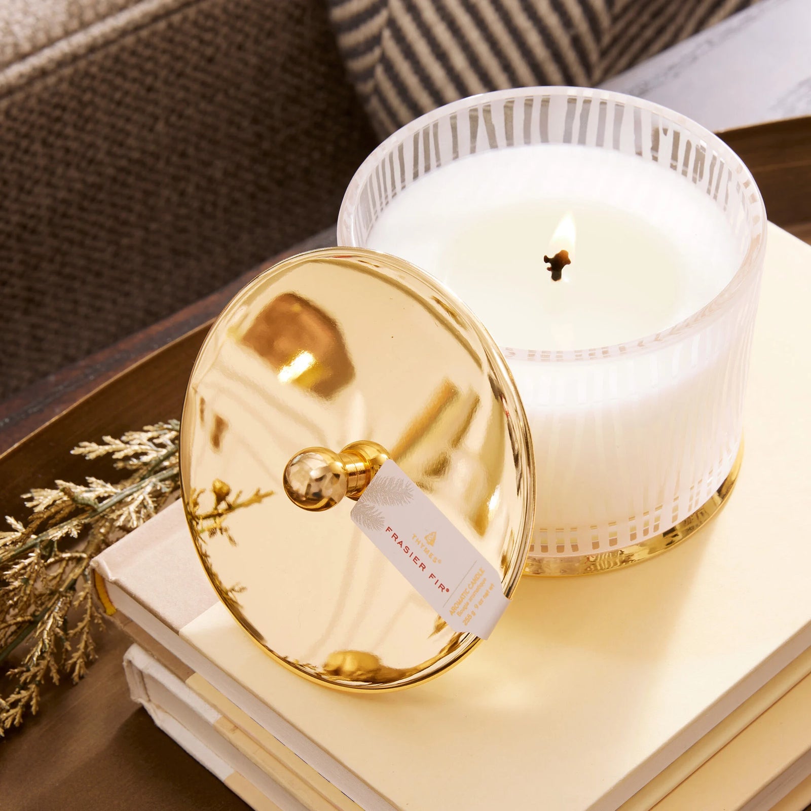 Gilded frosted wood grain Frasier Fir candle. White glass jar with gold metal lid. Thymes. Holiday candle. 