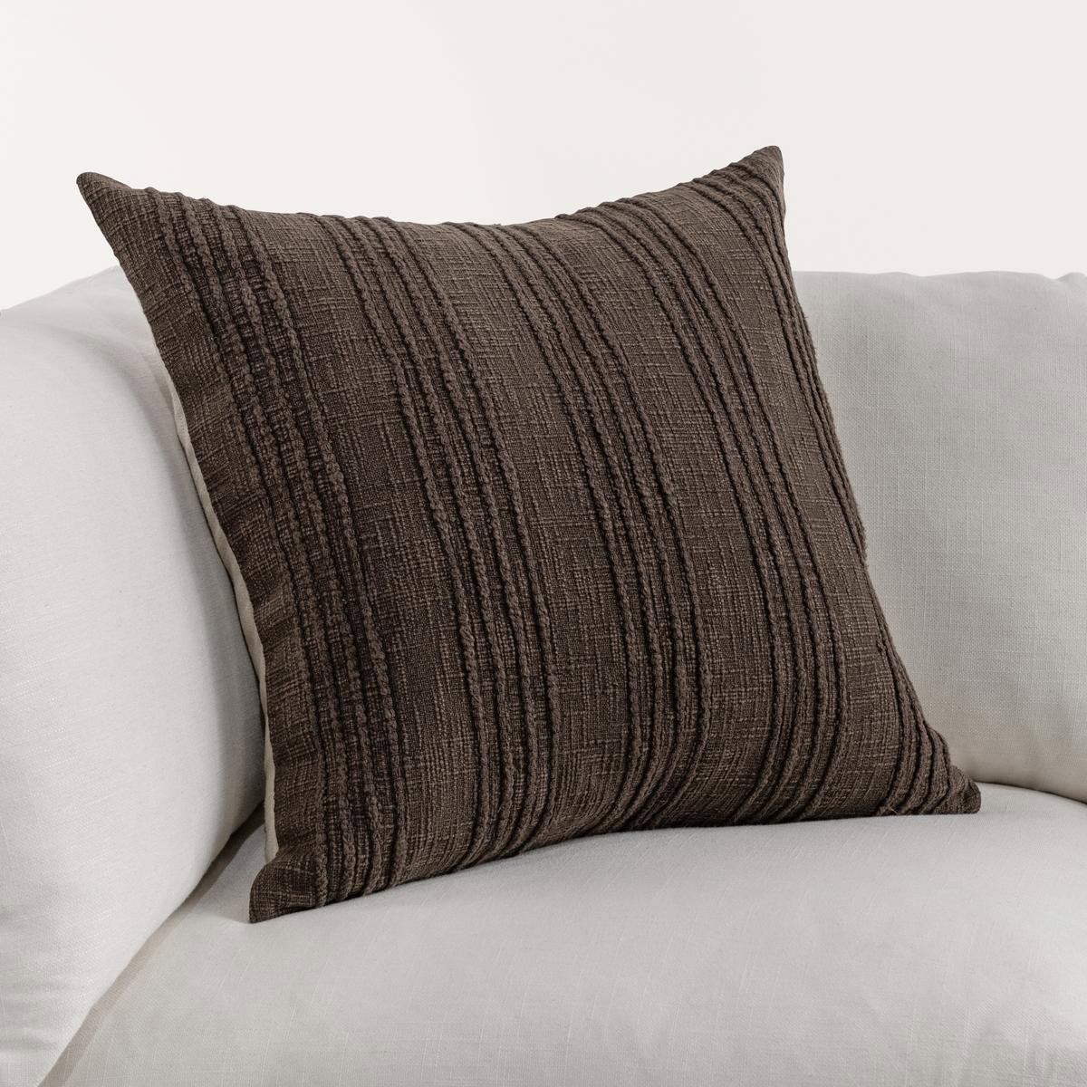 Textured stripe brown pillow on a light gray sofa. 22x22 Cotton pillow.