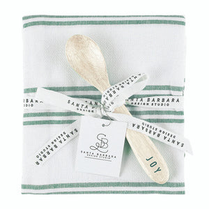 Set of wooden spoons with 'JOY' on a striped towel, branded 'Santa Barbara Design Studio'.