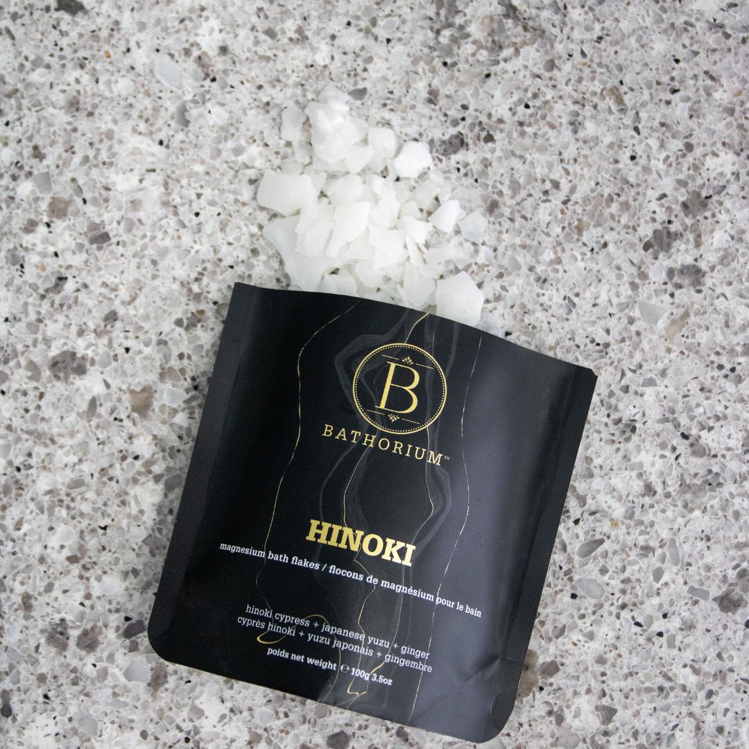 Bathorium "Hinoki magnesium bath flakes" opened on a marble surface.