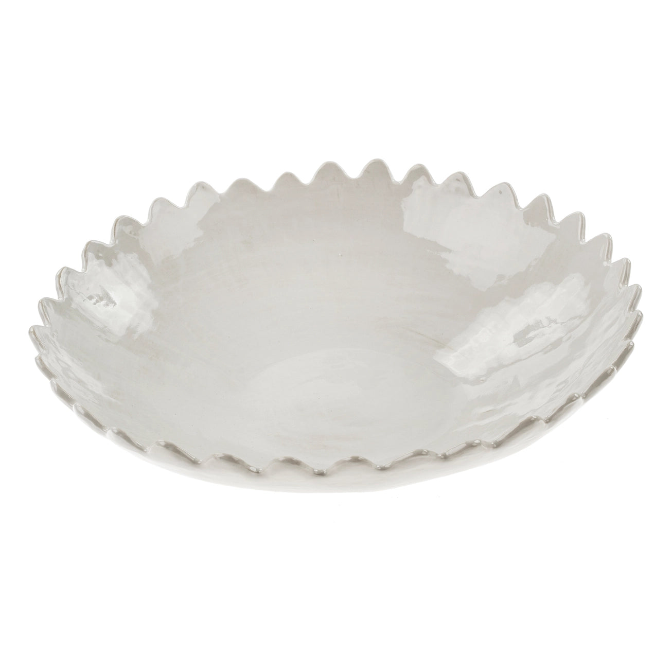 White ceramic scalloped rim bowl on a white background. 