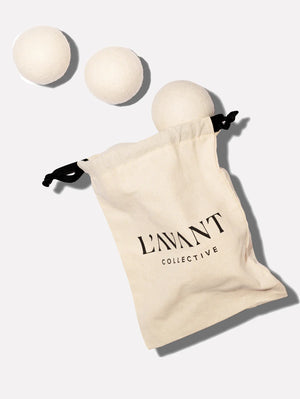 White bag with three wool dryer balls