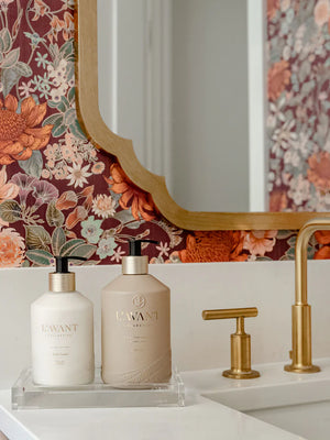 Bathroom display of hand lotion and soap from L"AVANT Collective on a double clear acrylic display tray. 
