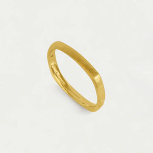 Gold bangle bracelet against a white background. Dean Davidson jewelry
