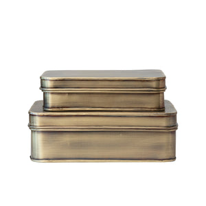 Set of two brass-colored rectangular metal decorative boxes on a white background
