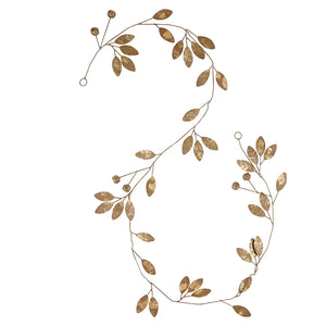 Individual gold metal leaf designed garland against white background. 