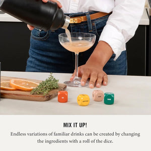 Person pouring a drink into a glass with dice and herbs on a table, text 'Mix It Up!' displayed.
