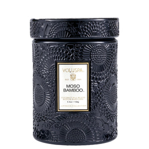5.5 ounce dark embossed glass jar candle in scent Moso Bamboo from Voluspa. 