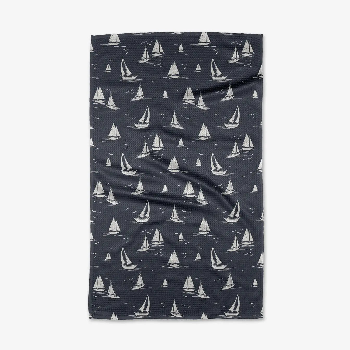 Navy tea towel with white sailboat pattern on a white background. Geometry House. 