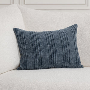 Navy blue stripe textured lumbar pillow on a light gray sofa.