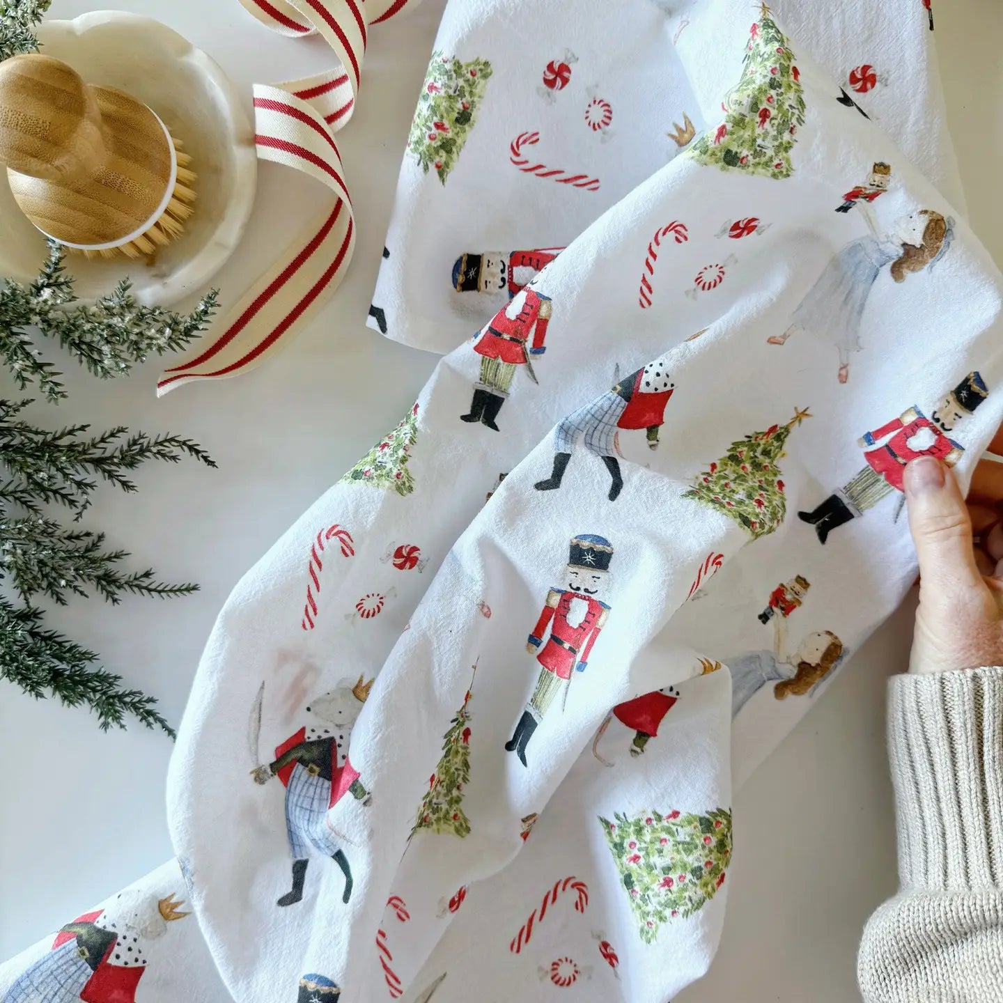 Nutcracker Christmas themed fabric with nutcrackers, trees, and candy canes against a winter background. Emily Lex Studio. 