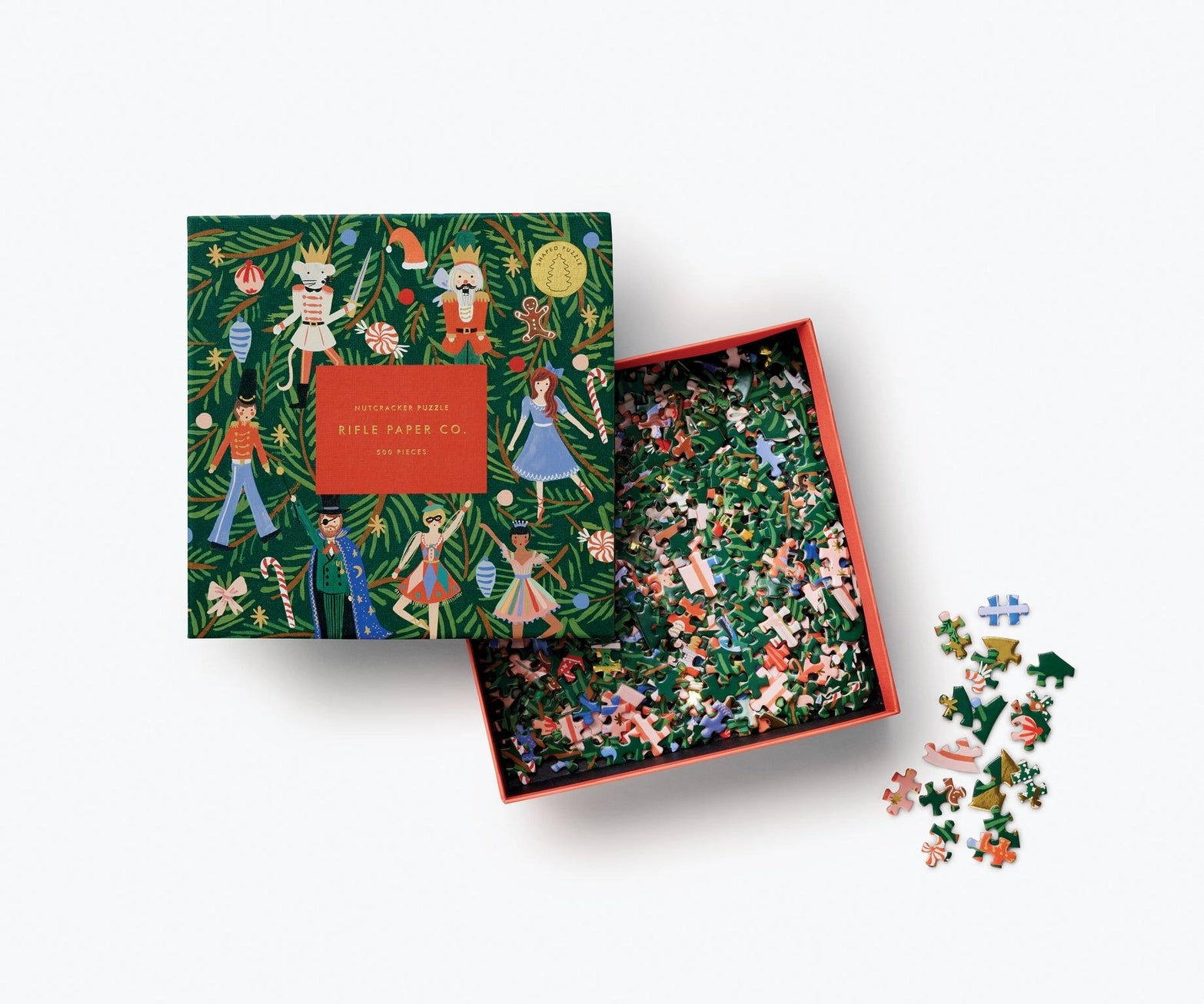 Holiday jigsaw puzzle set with a decorative box featuring illustrations of nutcrackers and ballerinas on a christmas tree. Rifle Paper Co. 