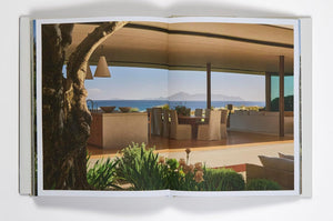 Open book showing a photographed modern outdoor living space with ocean view from "Pacific Natural Everywhere" By Jenni Kayne. 