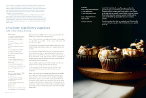 A two-page recipe spread for chocolate-blackberry cupcakes with cream cheese frosting, featuring a large ingredient list on the left and a photo of three decorated cupcakes on the right. "Rooted Kitchen". 