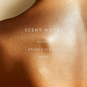 Text "SCENT NOTES OZONE ORANGE FLOWER MUSK" on a dewy skin textured background. 