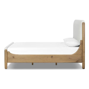 Wooden bed frame with white mattress and pillow on a white background