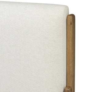 Close-up of a textured white headboard with wooden post on a white background