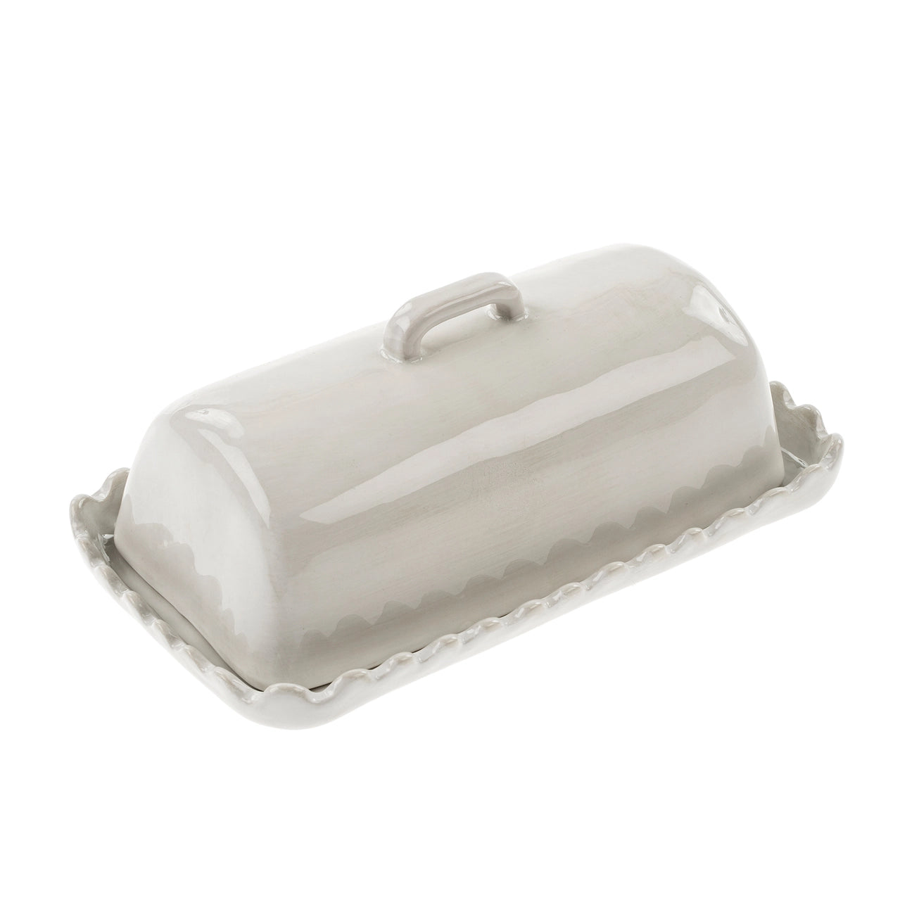 Scalloped white ceramic butter dish with lid on a white background.