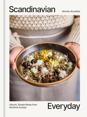 Book cover of 'Scandinavian Everyday' written by Nichole Accettola, with a bowl of prepared soup held by a person's hands. 