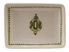 A square ceramic dish with a cream-colored glaze, featuring a green decorative ornament motif in the center and a green rope-like border around the rim.