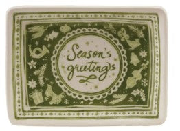 A square ceramic serving tray with a festive green and cream holiday design. The center features a circular medallion with the words 'Season's greetings' in cursive script, surrounded by decorative illustrations of Christmas trees, ornaments, and snowflakes.