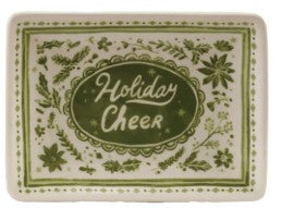 A square ceramic plate with a vintage holiday design, featuring green floral patterns and the words 'Holiday Cheer' in white script inside a green oval on an off-white background.