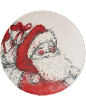 A round white plate featuring a hand-drawn style illustration of Santa Claus in red and black sketch lines, with a red gift box and bow on the left side.