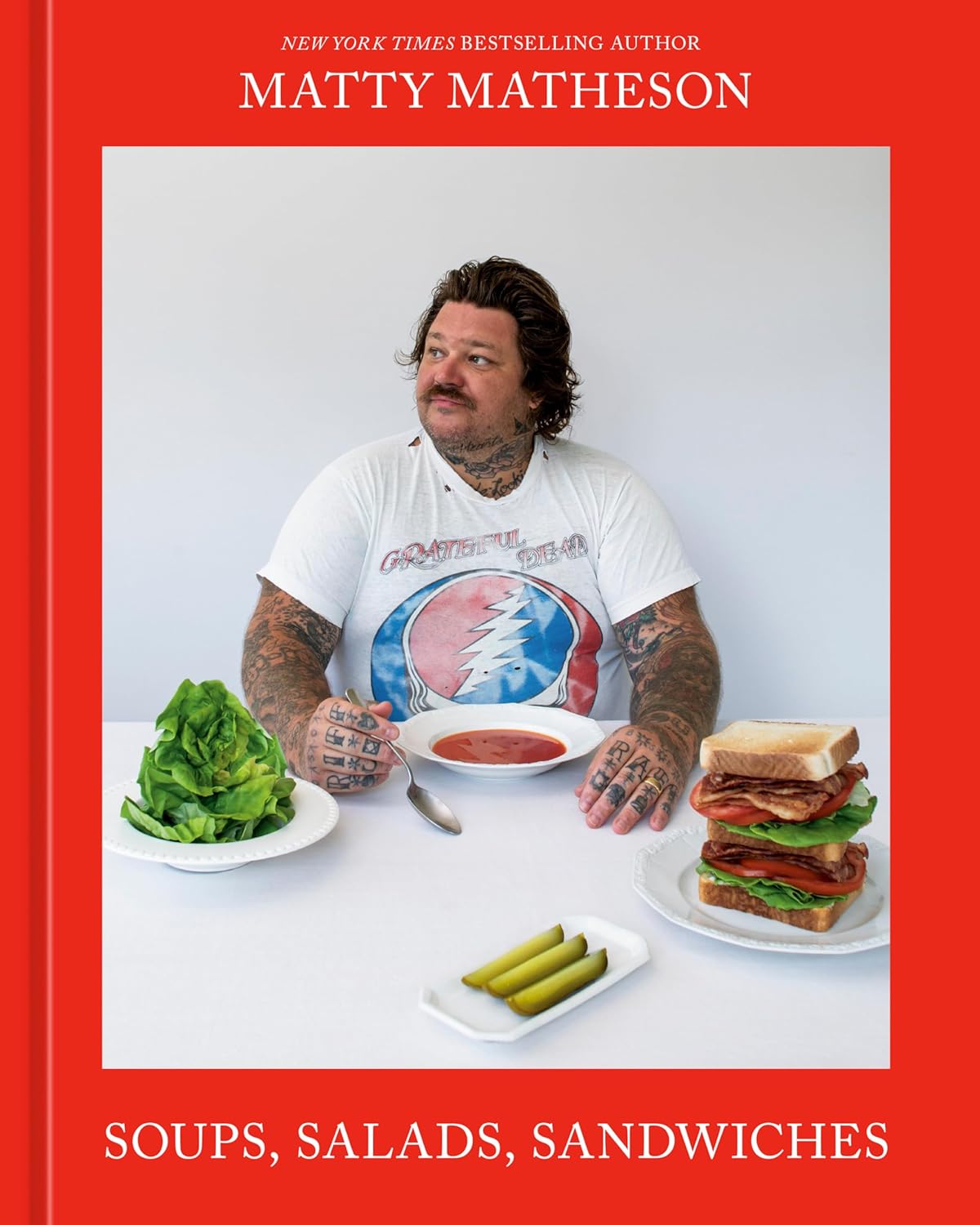 Matty Matheson photographed on front cover siting at table eating soups, salads, and sandwiches. 
