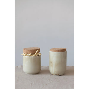Set of two taupe swirled marble stoneware vases with cork lid. One is filled with dried pasta. 