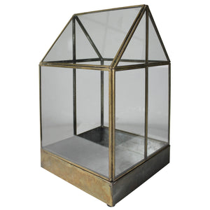 Antique glass terrarium with gable roof pitch, with a removable metal base on a white background.